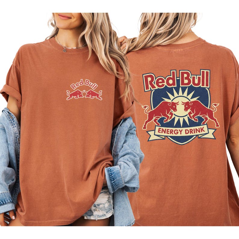 A woman wearing a red bull t-shirt with the Red Bull logo and the text "Red Bull ENERGY DRINK" on the back.