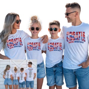 A group of four people, two men and two women, wearing matching white t-shirts with the text "Cromatia demo Hrvatska!" printed on them.