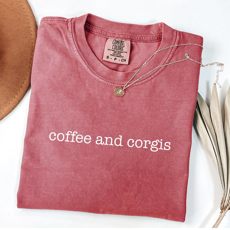 a red shirt that says coffee and corgis on it