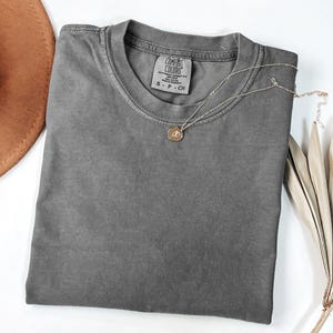 a hat, a t - shirt, and a pair of scissors on a white
