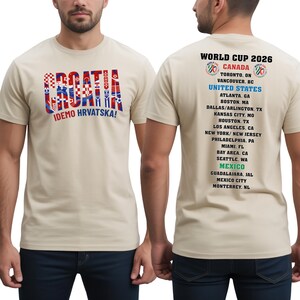 a man wearing a cream-colored t-shirt with text and graphics related to the Croatia national soccer team.
