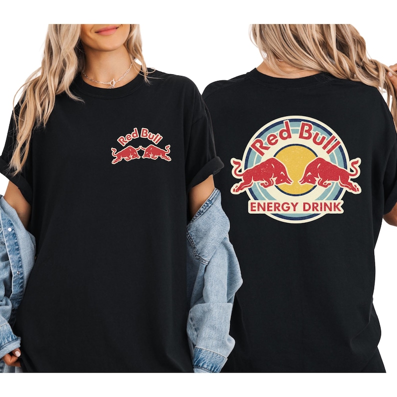 A woman wearing a black t-shirt with the Red Bull logo and the text "Red Bull ENERGY DRINK" printed on it.