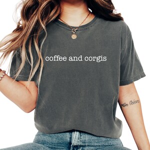 a woman wearing a coffee and corgis shirt