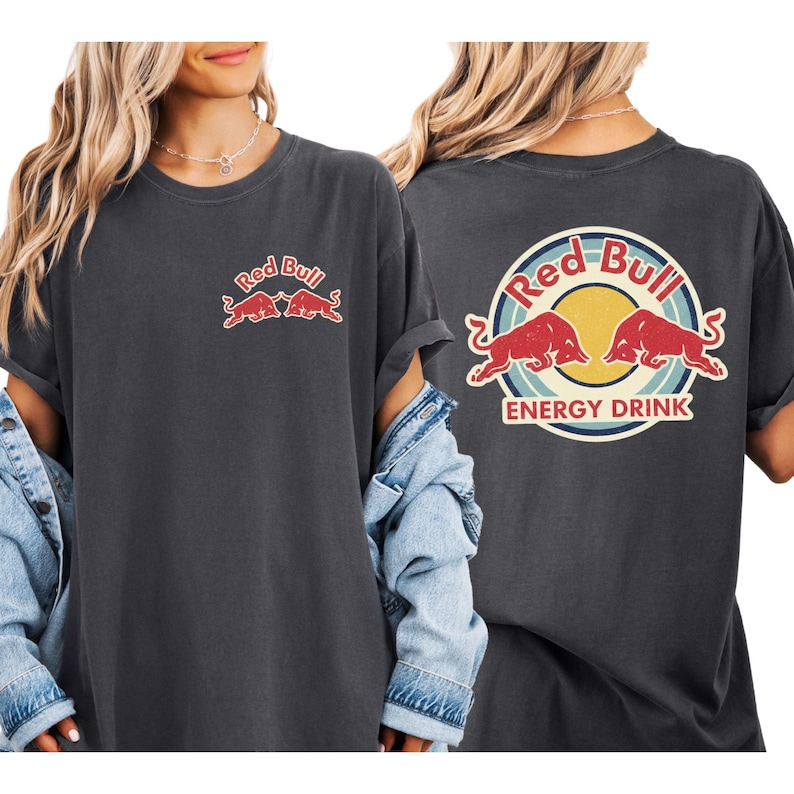 two women wearing black t-shirts with the Red Bull logo and the text "Red Bull ENERGY DRINK" printed on them.