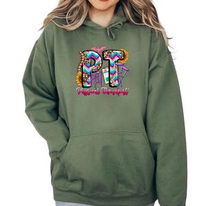 a woman wearing a green hoodie with the letter p on it