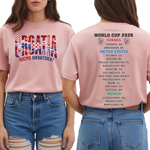 a woman wearing a pink t-shirt with text and graphics on the back, including a list of locations and a graphic design.