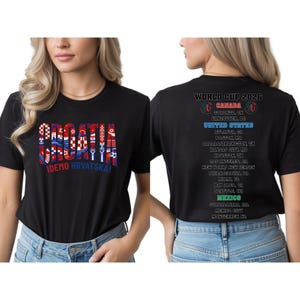 a woman wearing a black t-shirt with text and graphics printed on it.