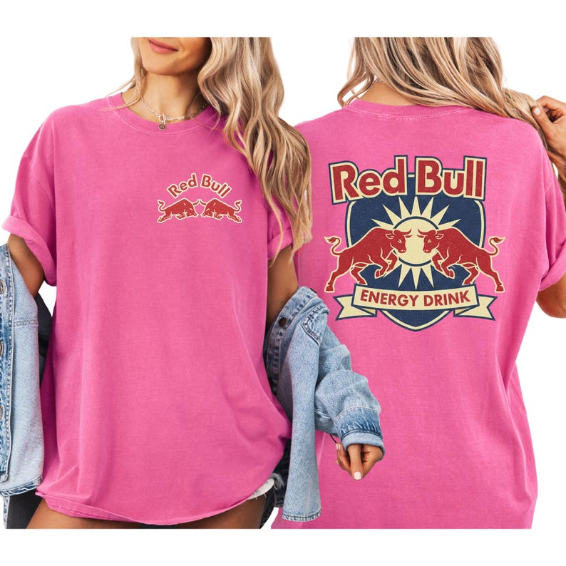 A woman wearing a pink t-shirt with the Red Bull logo and a denim jacket.