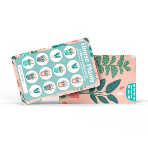 May include: A light blue card with the text "House Plants Savings Challenge" and instructions to colour in all the shapes to save. The card has a grid of nine plant shapes to colour in. The card is on top of a pink and green patterned card.