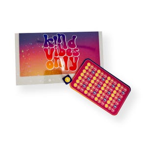 May include: A rectangular card with a gradient background featuring the text "kind vibes only" in a retro font, paired with a smaller rectangular tracker card containing rows of circles labeled with numbers 10, 20, 30, and 50, plus a small square die.
