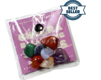 May include: A clear plastic bag with a pink card inside that says "Chakra Balancing Stones". The bag contains seven small, colorful stones.