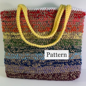 A crochet bag made with yarn and plastic grocery bags sits upright. The handles hang down to one side.