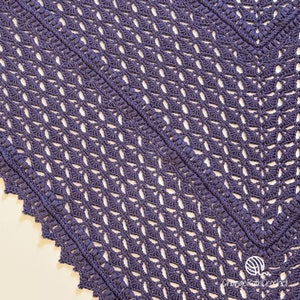 May include: A close-up of a handmade, dark purple crochet shawl. The shawl features an open, lacy design with a scalloped edge. The texture is visible, showcasing the intricate stitch work. The ChangePathCrochet logo is in the bottom right corner.