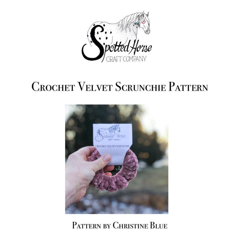 May include: A close-up of a dusty rose velvet scrunchie with a white tag that reads "Spotted Horse Craft Company" and "Crochet Velvet Scrunchie". The scrunchie is held in a hand against a blurred background.