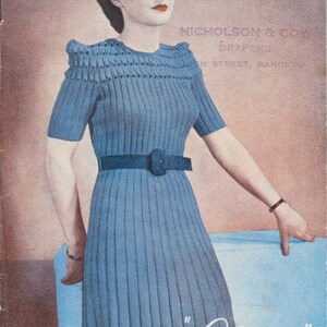 May include: A vintage knitting pattern booklet featuring a woman wearing a blue knitted dress with a belt. The cover reads "Canterbury Nicholson & Co. Drapers  M Street, Rangiora" and "Charm Frock Book Book I Price 1/-"