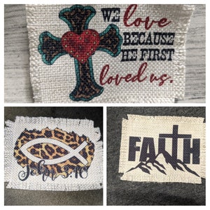 May include: Three burlap patches with Christian-themed designs. The first patch features a cross with a heart and the text "We love because he first loved us." The second patch features a fish with the text "John 3:16." The third patch features a cross with the text "FAITH" and mountains.