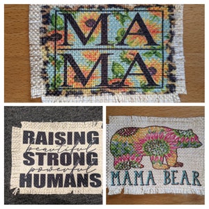 May include: Three burlap patches with floral designs and text. The first patch says "Mama" in black letters. The second patch says "Raising beautiful strong powerful humans". The third patch has a floral bear and says "Mama Bear".