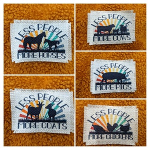 May include: Five fabric patches with a rustic, vintage look. Each patch features a sunset with a silhouette of an animal and the text "Less People, More [Animal]" with the animal being horses, goats, cows, pigs, and chickens.