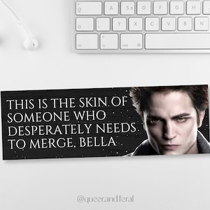 May include: A black and white image of a man with a serious expression. The text "THIS IS THE SKIN OF SOMEONE WHO DESPERATELY NEEDS TO MERGE, BELLA." is written in white on a black background. The text "@queer.and.feral" is written in white at the bottom of the image.