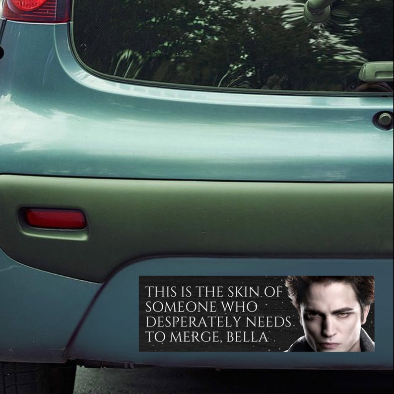 May include: A black and white bumper sticker with a quote from the Twilight movie series. The quote reads "This is the skin of someone who desperately needs to merge, Bella." The sticker features a photo of Edward Cullen, a vampire character from the Twilight series.