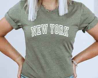May include: A green t-shirt with the text "NEW YORK" in white outlined letters.