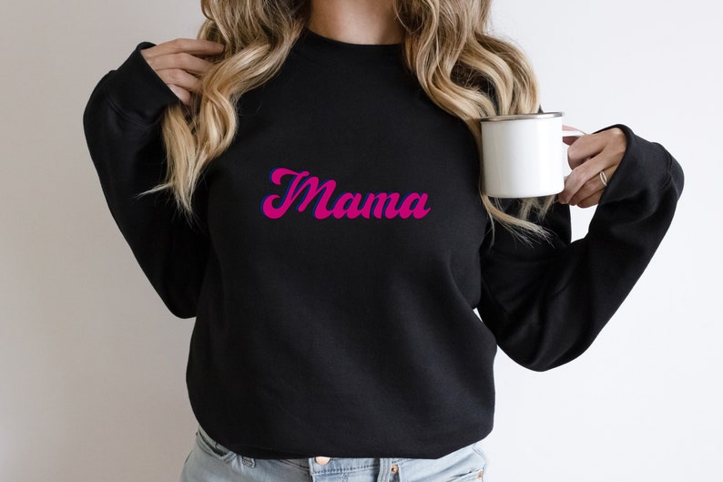 May include: A black sweatshirt with the word "Mama" printed in pink and blue lettering.