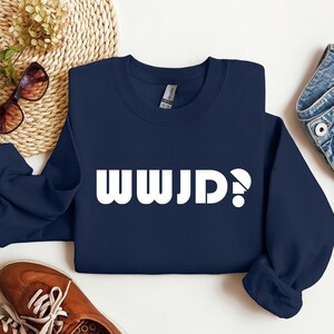 May include: Navy blue sweatshirt with white text that reads "WWJD?"