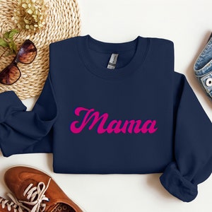 May include: A navy blue sweatshirt with the word "Mama" in pink cursive lettering.