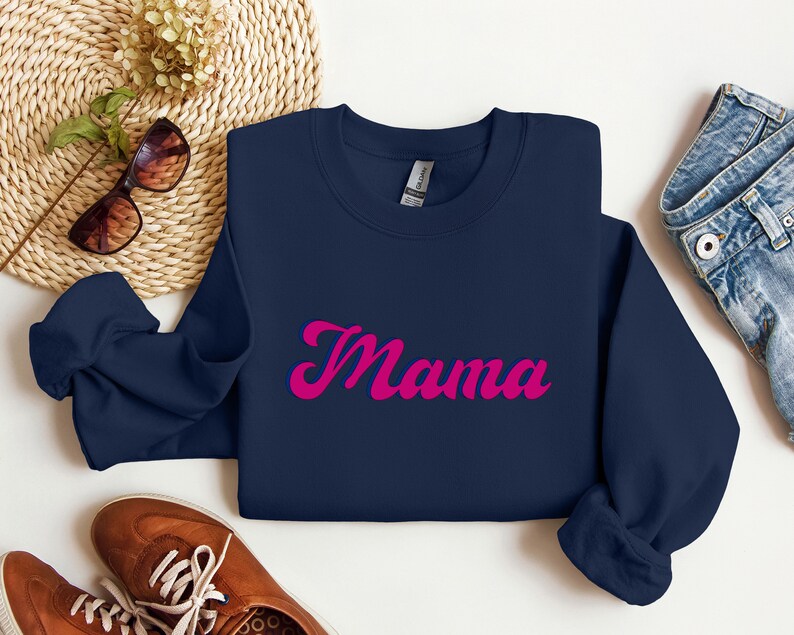 May include: A navy blue sweatshirt with the word "Mama" in pink cursive lettering.