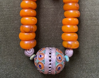Moroccan enamelled egg bead with faux amber resin beads from Nepal, strung on leather thong to make an adjustable length.