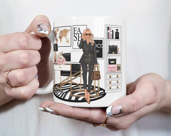 May include: White ceramic mug with a black and white illustration of a woman in a black suit and sunglasses sitting at a desk with a zebra print rug. The text "Fashion Shopaholic" is on the wall behind her.