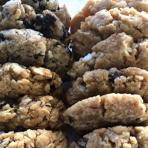 May include: A close-up of two stacks of homemade cookies. One stack is oatmeal raisin cookies and the other stack is chocolate chip cookies.