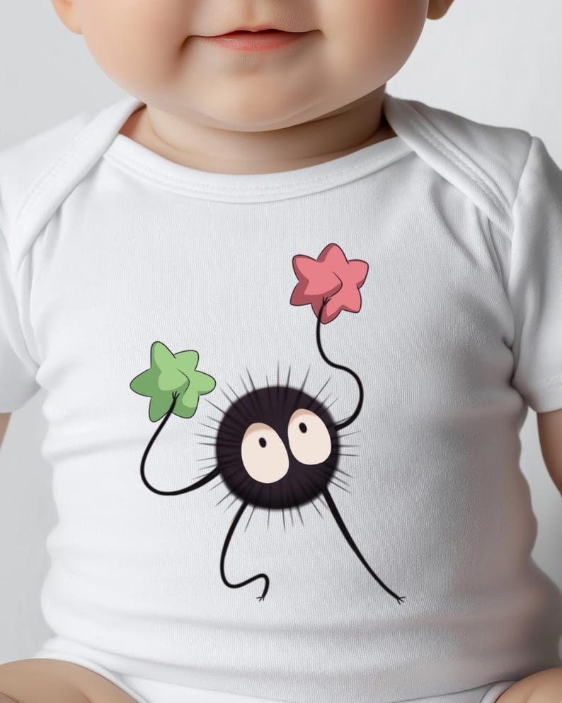 May include: White baby onesie with a black and white cartoon character holding a pink and a green star. The character has two large eyes and a spiky body.