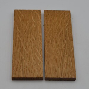 May include: Two rectangular pieces of wood with a natural wood grain pattern. The wood is a light brown color.