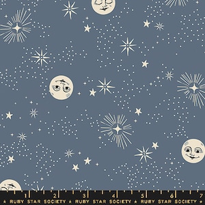 May include: A blue fabric with a repeating pattern of white stars, moons, and stylized starbursts. The moons have closed eyes and a small smile.