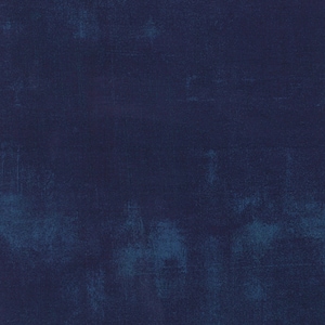 May include: A dark blue textured background with a slightly lighter blue hue in the center.