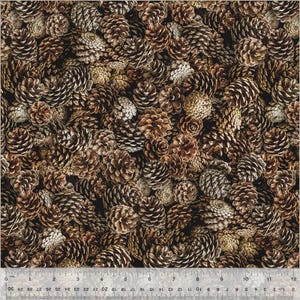May include: A close-up image of a fabric with a brown and tan pattern of pine cones. The fabric is perfect for crafting projects, quilting, and home decor.