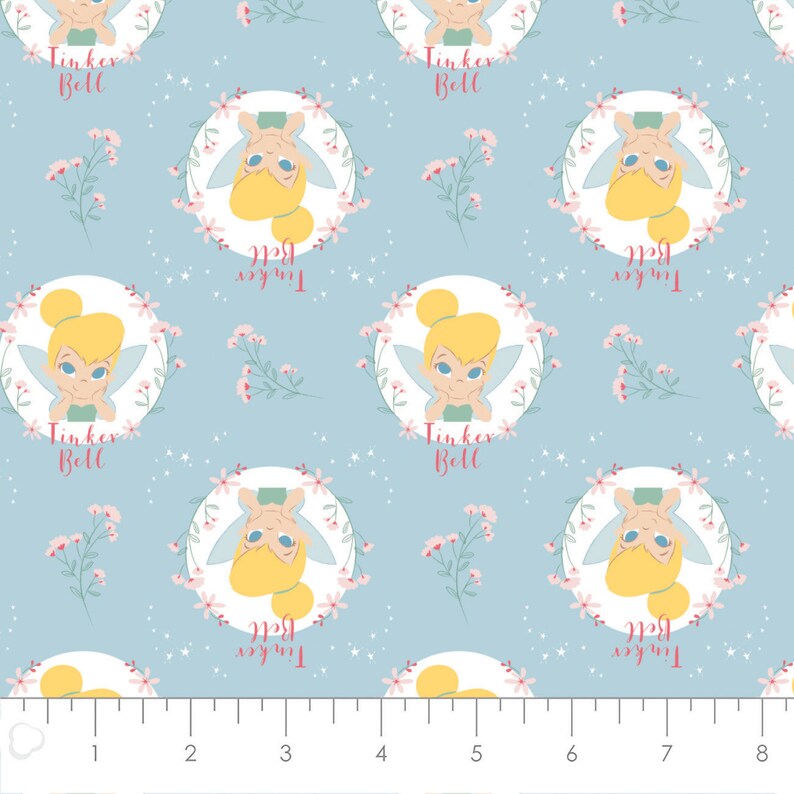 Camelot 85400303-2 Peter Pan Fabric by the Yard Tinker Bell Floral Badges Light Blue
