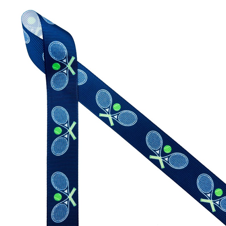 May include: A blue ribbon with a white tennis racket and green tennis ball pattern.