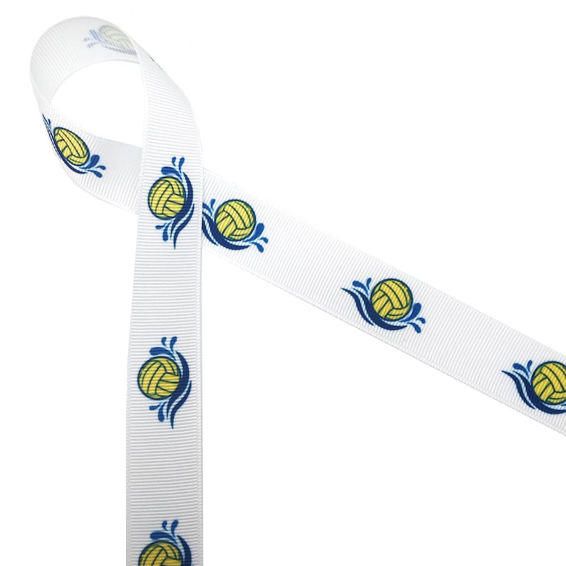 May include: White ribbon with a repeating pattern of yellow water polo balls with blue waves. The ribbon is folded in a loop.