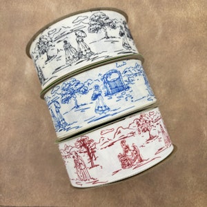 May include: Three rolls of white ribbon with blue and red printed designs. The designs feature people, trees, and buildings.