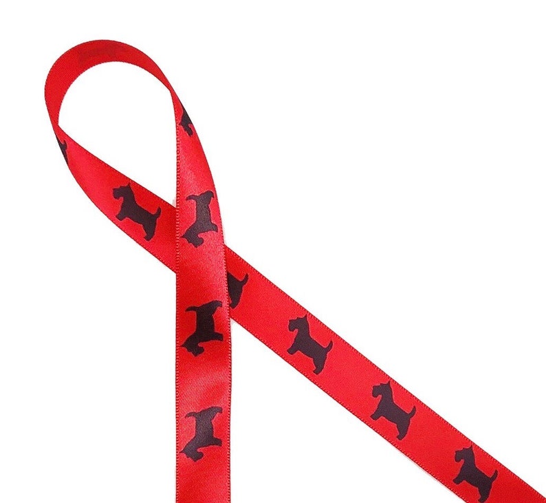 May include: Red satin ribbon with a repeating pattern of black dog silhouettes. The ribbon is looped and angled, showcasing the glossy texture and the contrasting colors of the design. Ideal for crafting or gift wrapping.