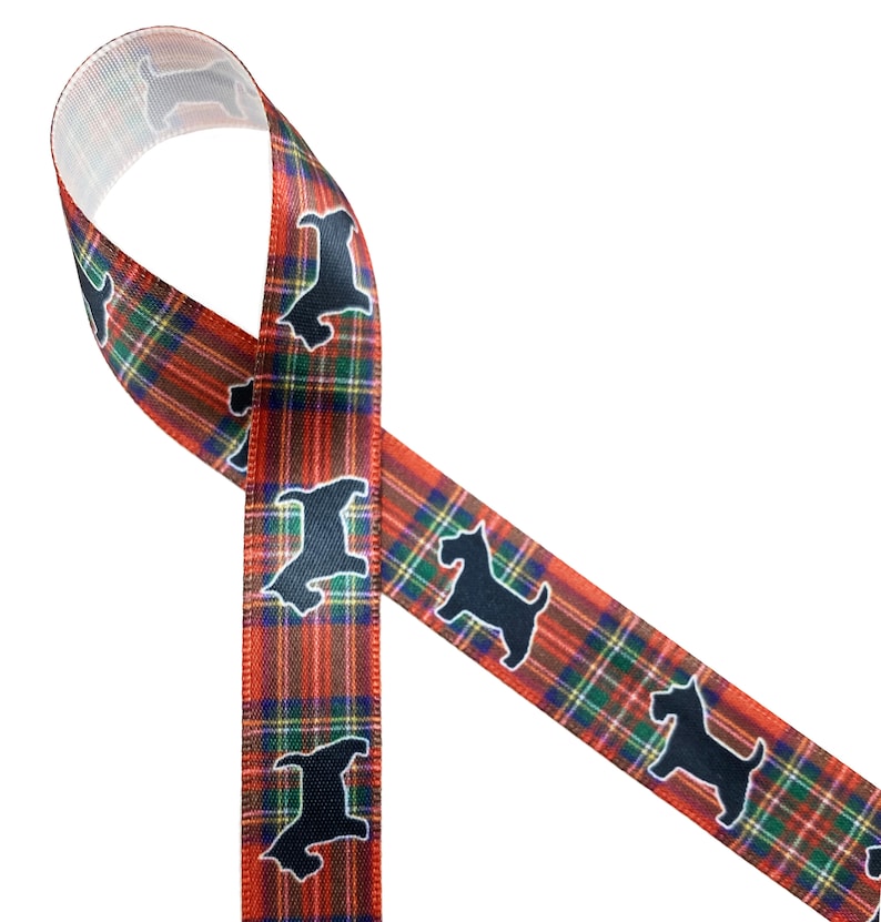 May include: A decorative ribbon featuring a classic plaid pattern in red, green, and blue. The ribbon is adorned with repeating black silhouette images of a dog. The ribbon is ideal for crafting and gift wrapping.