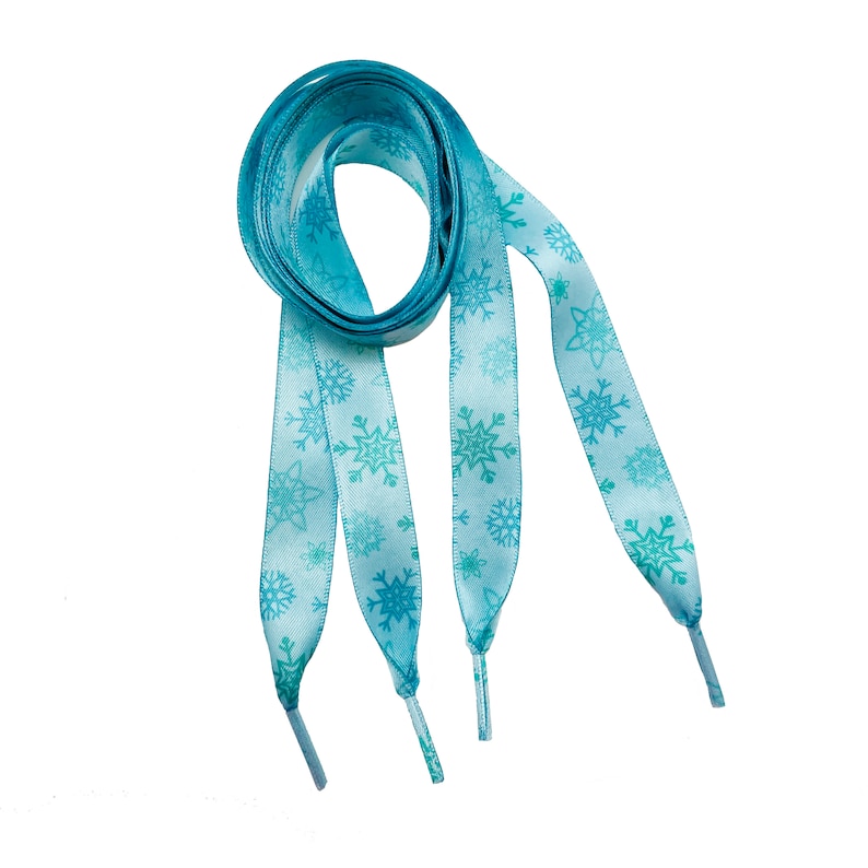 May include: A pair of light blue shoelaces with a snowflake pattern.