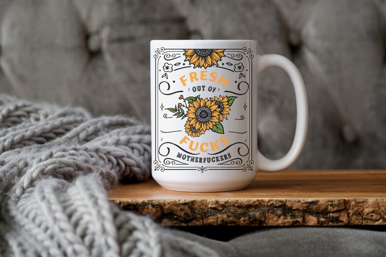 Fresh Out of Fcks mug with sunflower design, bold typography, geeky sweary drinkware.