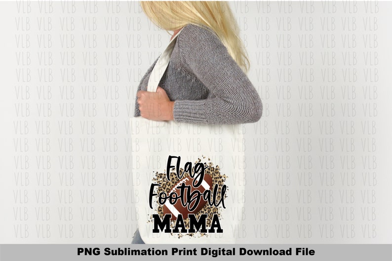 May include: A white tote bag with a brown and black leopard print design and a football graphic. The text "Flag Football Mama" is printed in black on the bag.