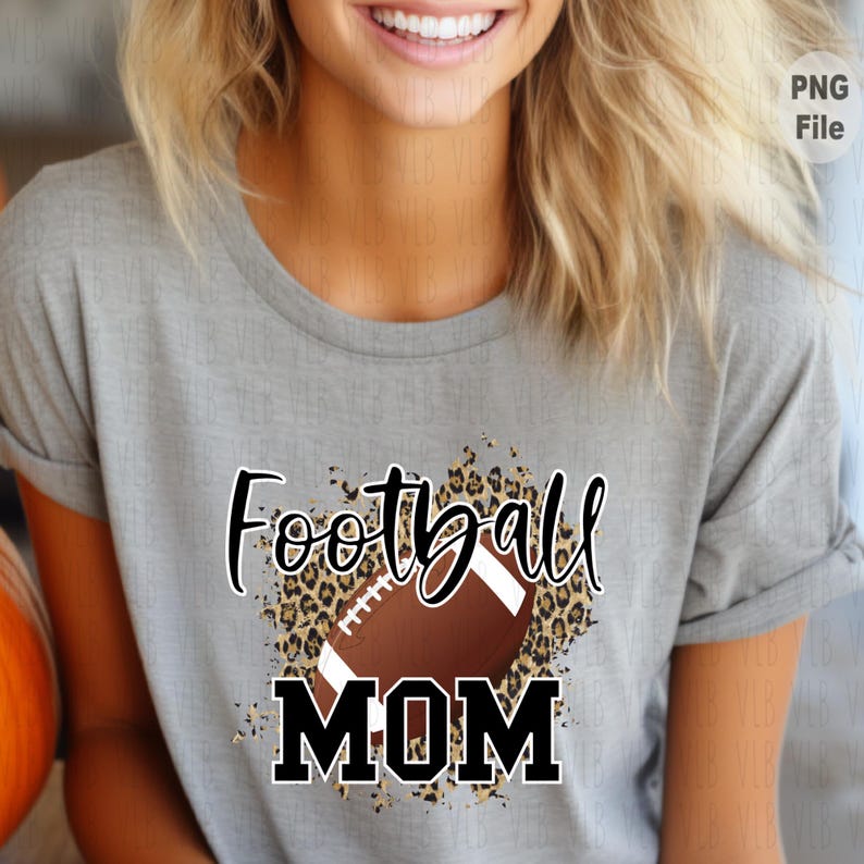 May include: A gray t-shirt with a brown football and leopard print design. The text "Football Mom" is printed in black.