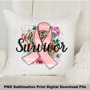 May include: A white pillow with a pink ribbon and floral design. The text "Survivor" is written in black cursive lettering.