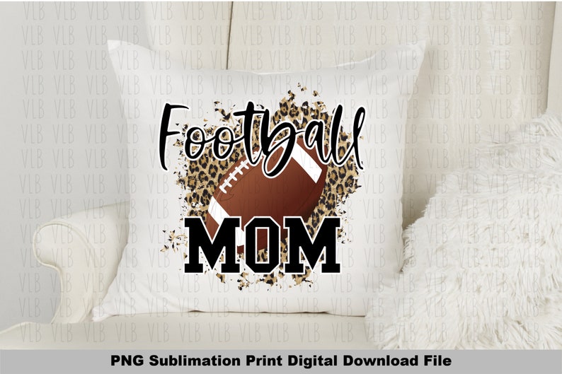 May include: A white pillow with a brown football and leopard print design. The text "Football Mom" is printed in black.