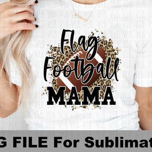 May include: A white t-shirt with a brown football and leopard print design. The text "Flag Football Mama" is printed in black.